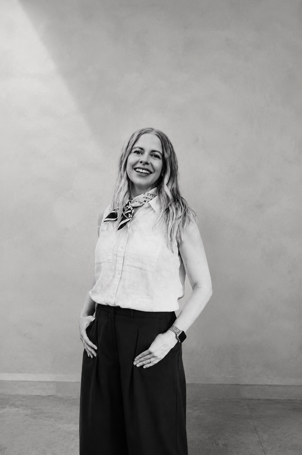 Tanya Cohn smiling in a black and white portrait